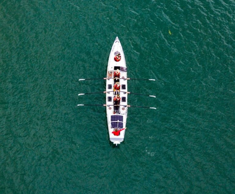 A picture of one of the ocean rowing boats on the sea taken by a drone in the sky