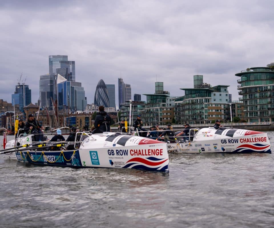Two ocean rowing boats side by side on the Thames river