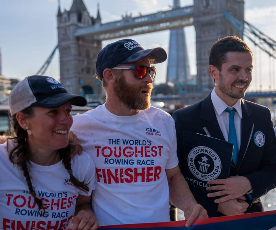 Rowers and Guinness World Record adjudicator in front of Tower Bridge, London